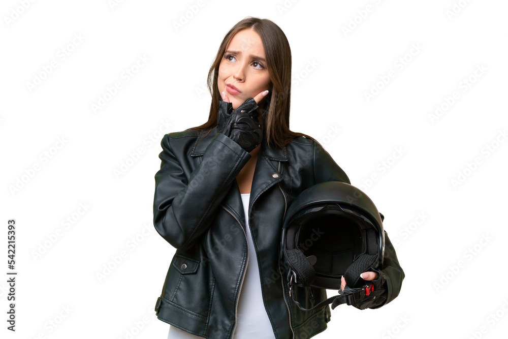 Young pretty caucasian woman with a motorcycle helmet over isolated background having doubts Young pretty caucasian woman with a motorcycle helmet over isolated background having doubts
