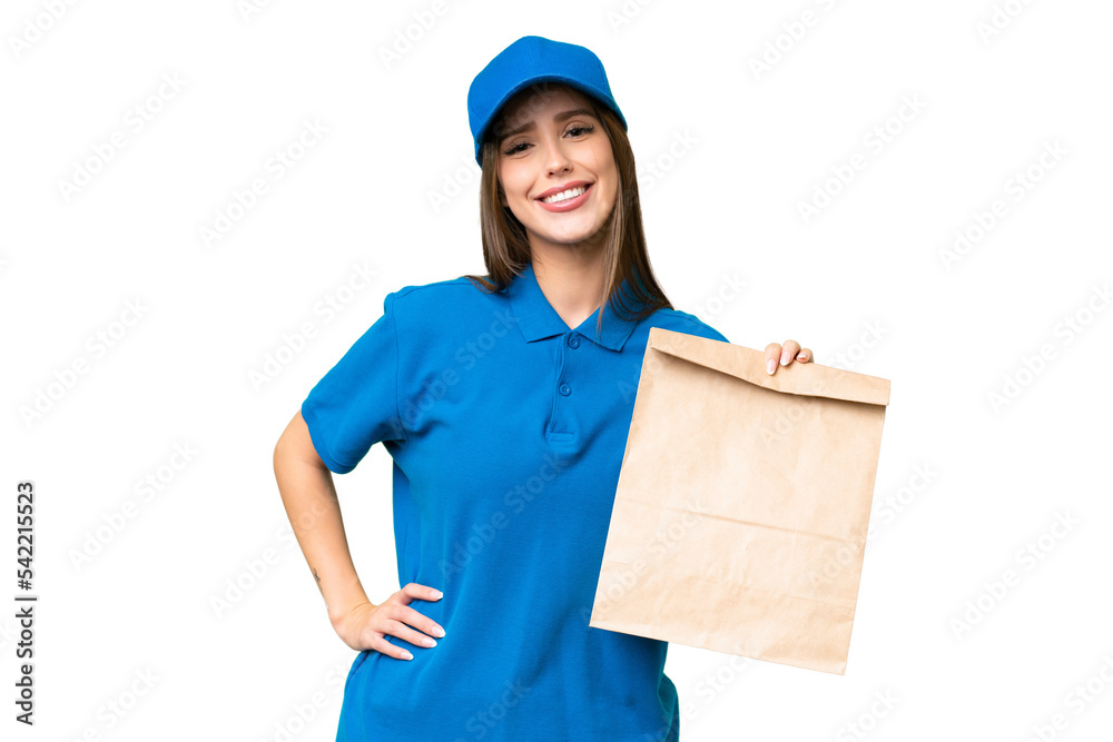 Young beautiful caucasian woman taking a bag of takeaway food over isolated background posing with arms at hip and smiling