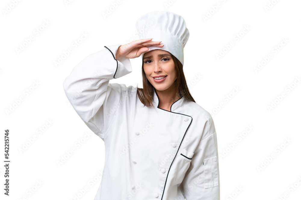 Young chef caucasian woman over isolated background looking far away with hand to look something