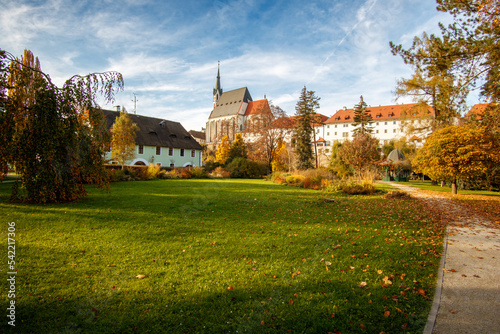 Picturesque autumn cityscape of Cesky Krumlov overlooking its historic centre and ancient Castle on bank of Vltava river, Czech Republic