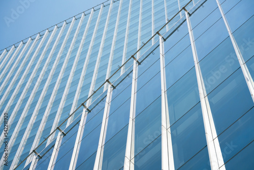 close-up soft light pattern glass wall facade exterior architecture building reflection blue sky clean environment background. modern business office concept,smart city backdrop cover minimal design.