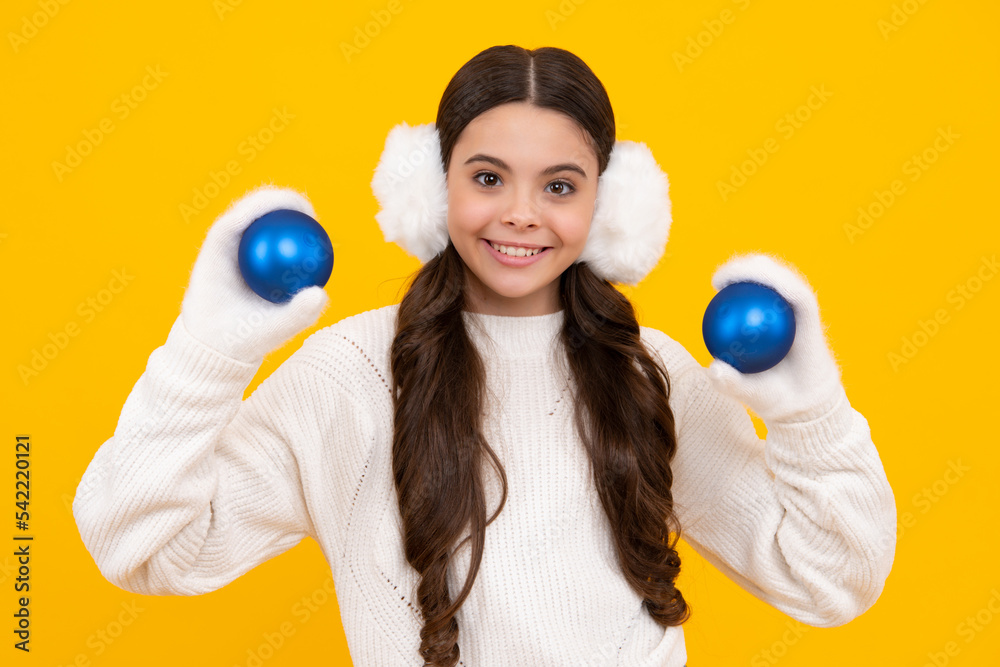 Merry christmas and happy New year. Kid in winter clothes. Teen girl with decorative christmas ball. Happy face, positive and smiling emotions of teenager girl. Merry christmas and happy New year. Kid in winter clothes. Teen girl with decorative christmas ball. Happy face, positive and smiling emotions of teenager girl.