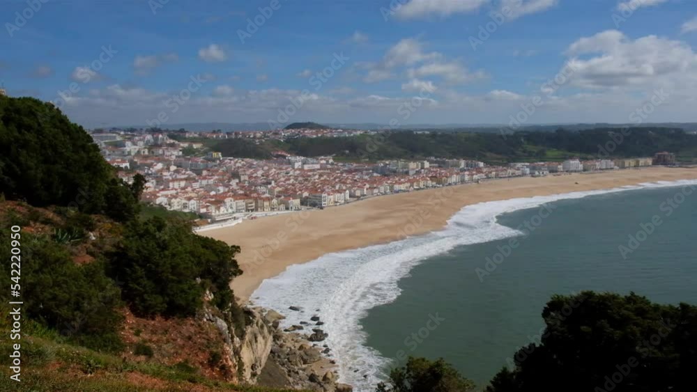 top view of the city of Nazare in Portugal, wide sandy beach and the Atlantic Ocean with waves top view of the city of Nazare in Portugal, wide sandy beach and the Atlantic Ocean with waves