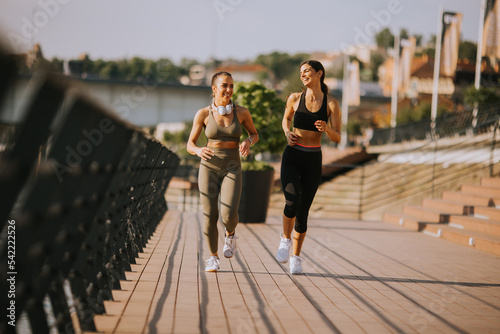 Young woman taking running ...