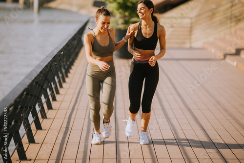 Young woman taking running ...