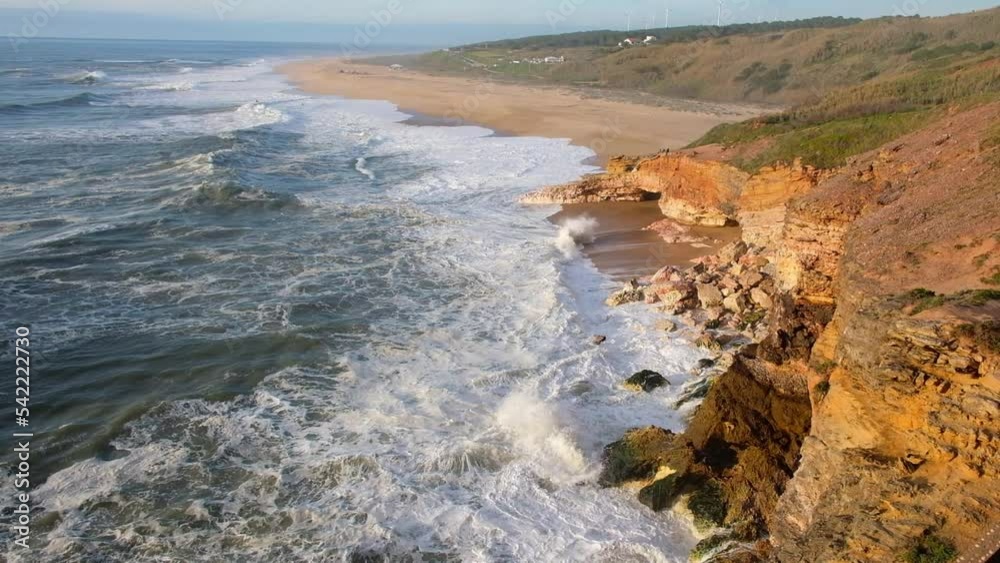 seascape, rocks and north beach with waves in the town of Nazare on the shores of the Atlantic Ocean. spring at evening seascape, rocks and north beach with waves in the town of Nazare on the shores of the Atlantic Ocean. spring at evening