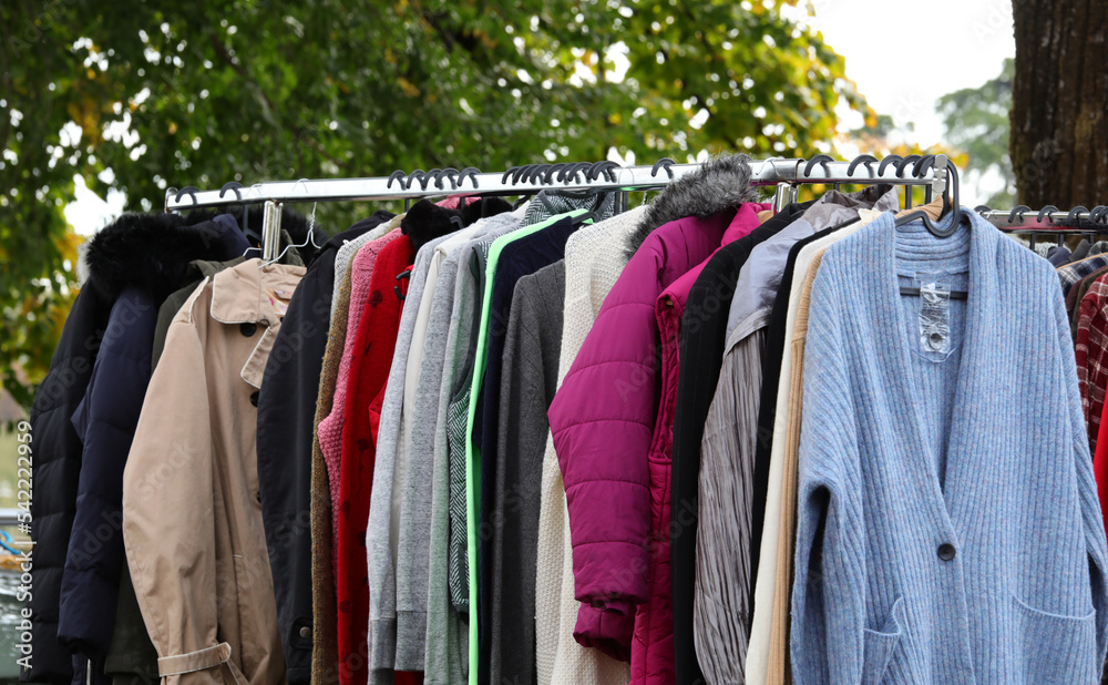 Obraz premium vintage used and new clothes for sale in the stall stand at the flea market