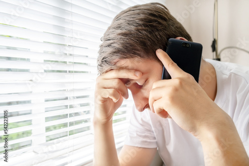 Sad Young Man with a Phone