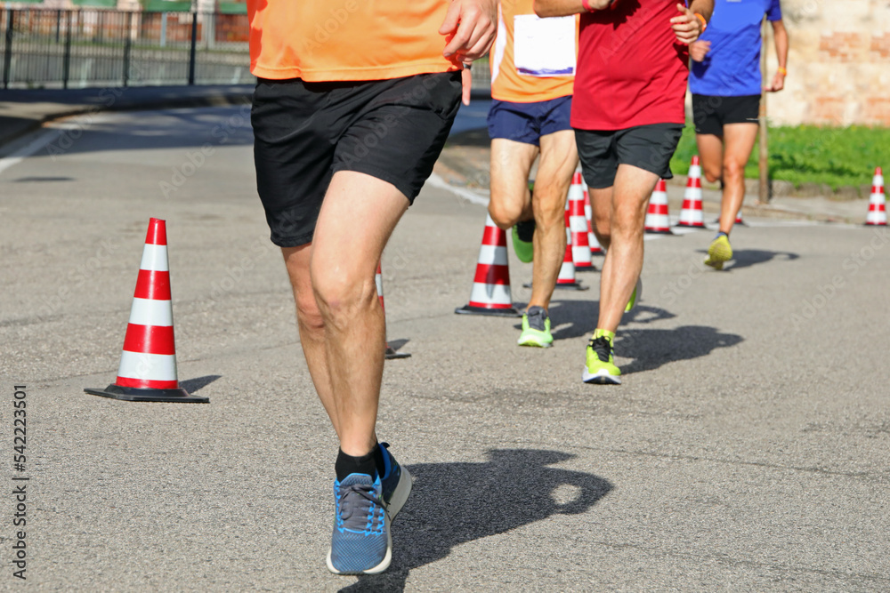 athletic runner with long muscular legs during the foot race
