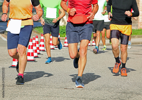 runners with muscular legs during the race