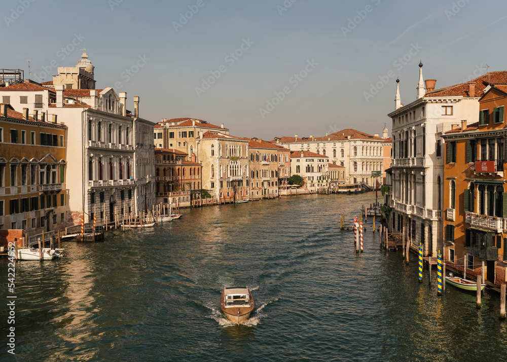 view of the grand canal and boat passing by in Venice, Italy