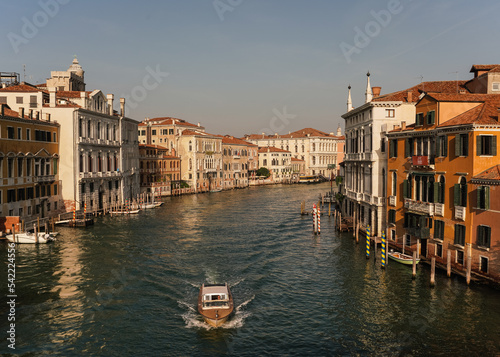 view of the grand canal and boat passing by in Venice, Italy