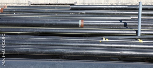 black pipes in the deposit of building material on the road cons photo