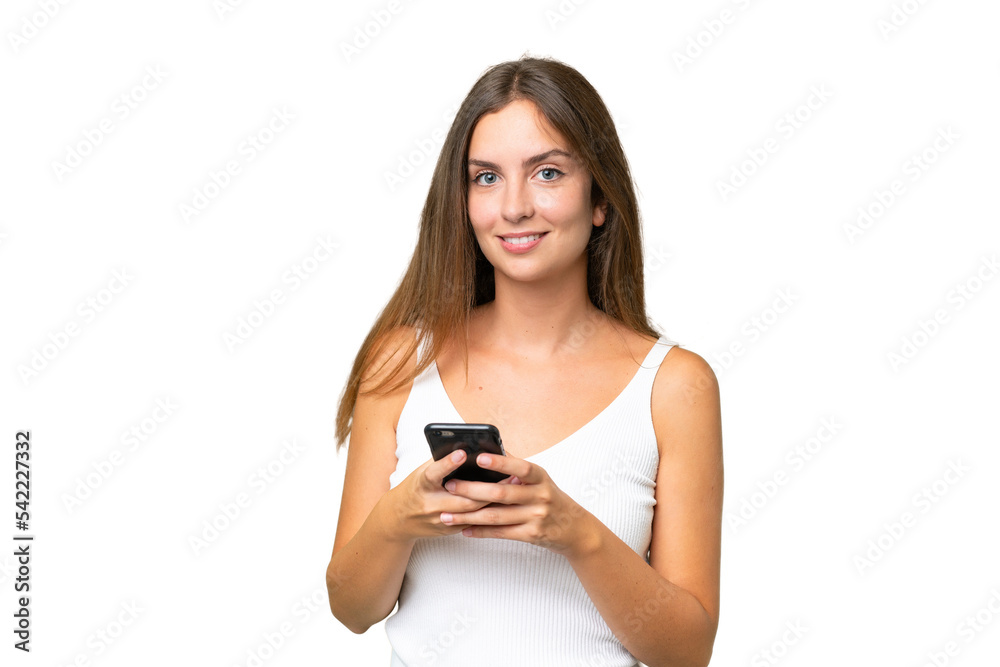 Young pretty woman over isolated background sending a message with the mobile Young pretty woman over isolated background sending a message with the mobile