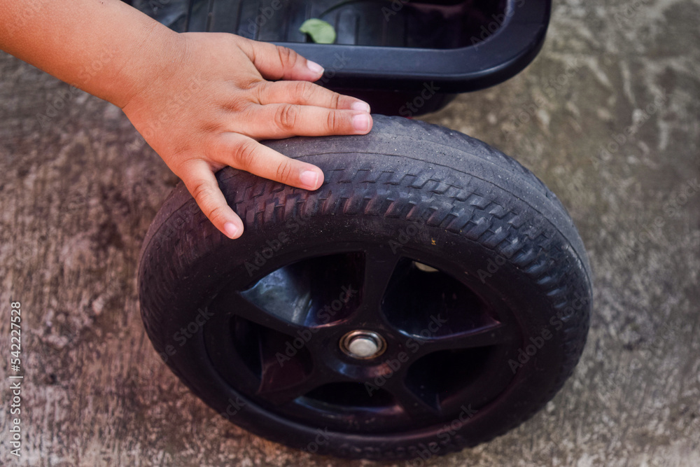 little mechanic working in garage and checking wheel tire. Repair or maintenance auto little mechanic working in garage and checking wheel tire. Repair or maintenance auto