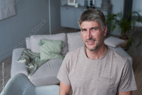 Portrait of happy successful man smiling at home