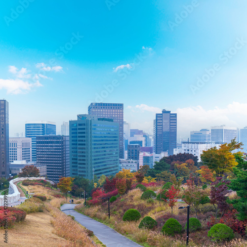 Fortress wall of Seoul city leading up to Namsan Baekbeom Plaza with autumn colorful park  Seoul   South Korea in autumn season