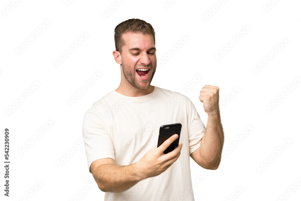 Young handsome caucasian man isolated on green chroma background with phone in victory position Young handsome caucasian man isolated on green chroma background with phone in victory position