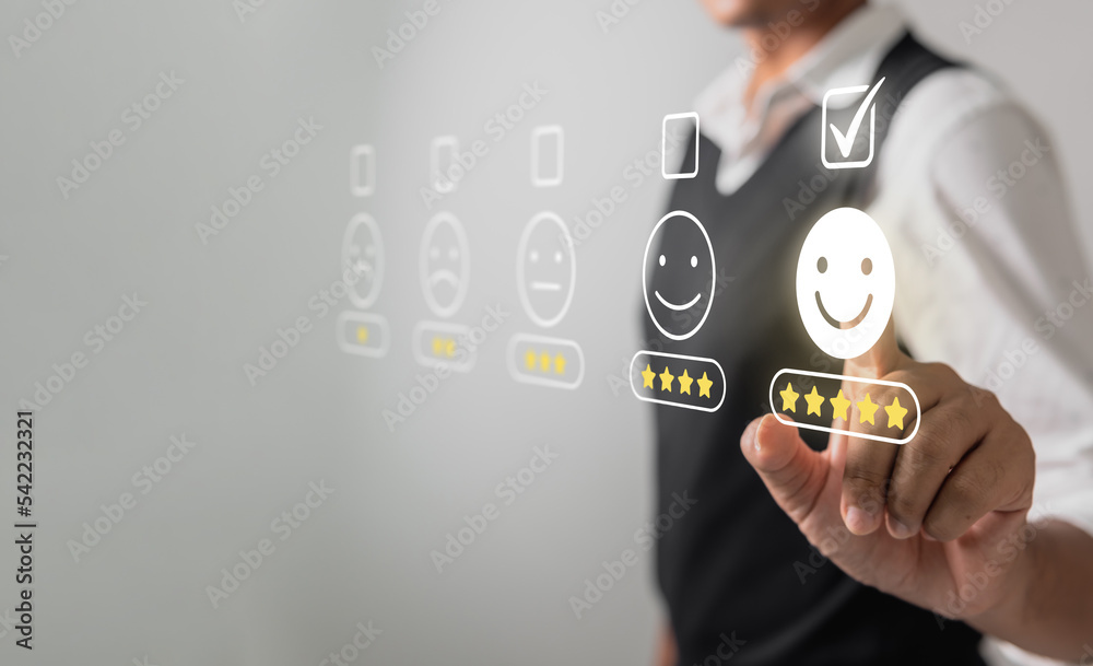 Fototapeta premium Businessman pressing face emoticon rating on virtual touch screen to service experience. Customer service and Satisfaction concept.
