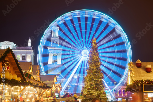 Christmas market with New Year Tree in Kyiv, Ukraine. The Ferris wheel and Christmas decoration at the Kontraktova Square