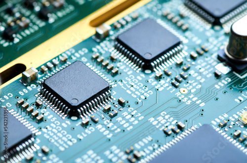 electronic board with microprocessor and electronic parts close-up, soft focus