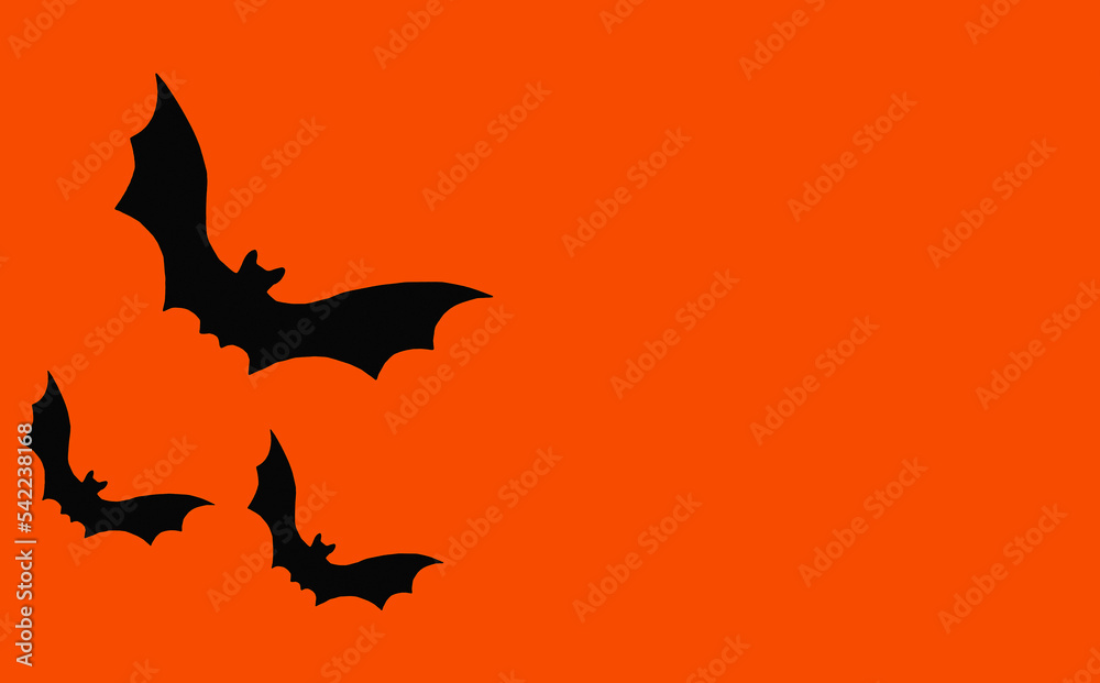 Fototapeta premium Silhouettes of bats on an orange background. Halloween