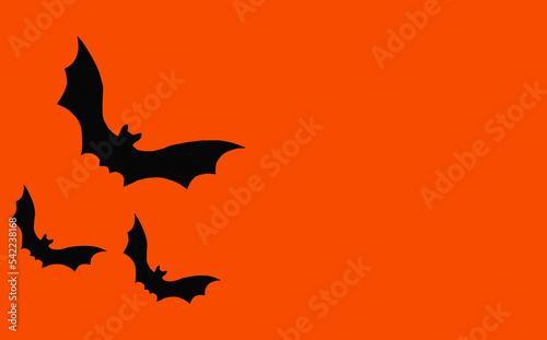 Silhouettes of bats on an orange background. Halloween