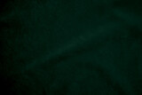 Dark green old velvet fabric texture used as background. Empty green fabric background of soft and smooth textile material. There is space for text...