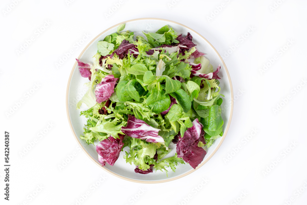 Green lettuce salad with fresh mixed vegetables isolated on white background. Top view, flat lay. Green lettuce salad with fresh mixed vegetables isolated on white background. Top view, flat lay.