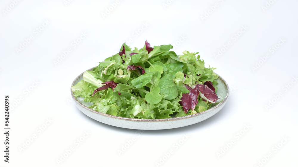 Green lettuce salad with fresh mixed vegetables isolated on white background. Green lettuce salad with fresh mixed vegetables isolated on white background.