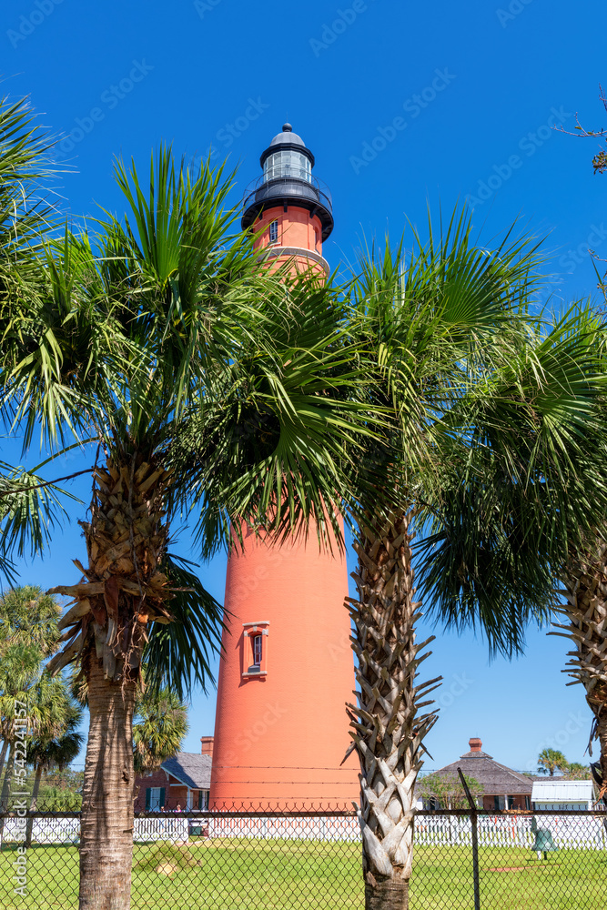Ponce Inlet Lighthouse and palm trees around, Daytona Beach, Florida.