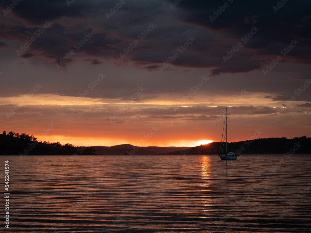 Breathtaking sunset view with seascape and a silhouette of boat