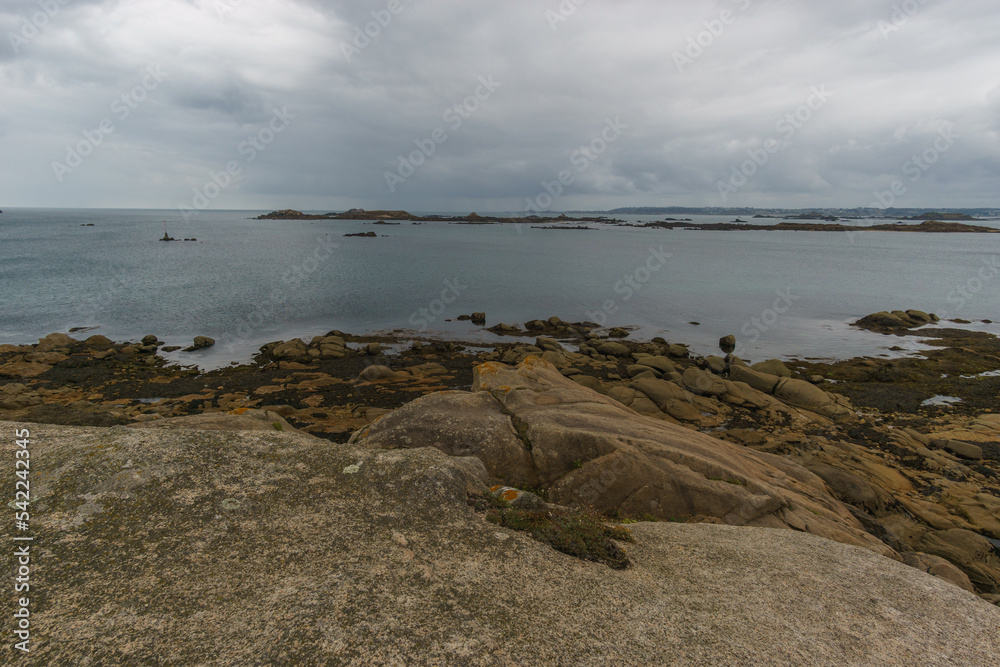 Small rock islands at low tide at the french coast seen from the island of Callot, Carantec, Brittany, France