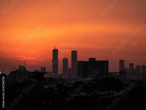 Silhouette of skyline against an orange sunset sky
