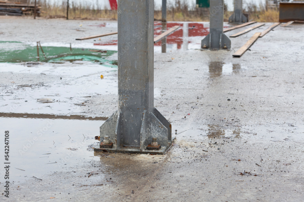 Metal structures on the construction of a house.Fastening of metal structures to the foundation. Metal structures on the construction of a house.Fastening of metal structures to the foundation.