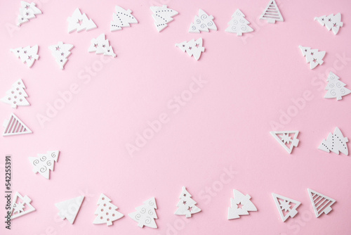 small white figures of a Christmas tree on a pink background with a place for text, Christmas concept, gifts,sale