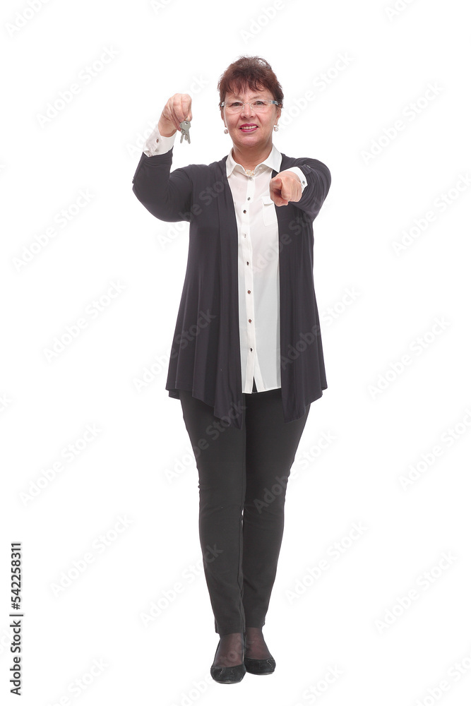 mature woman holding a couple of keys of her new house or home or some property mature woman holding a couple of keys of her new house or home or some property