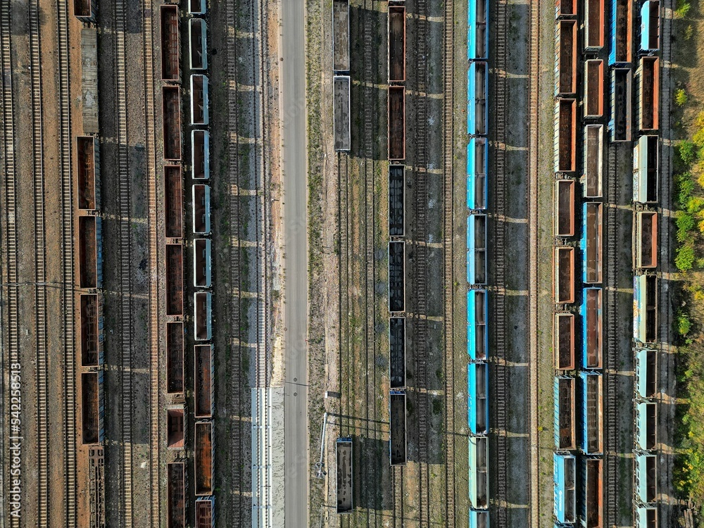 empty wagons are waiting at the train station for coal to be taken to the power plant