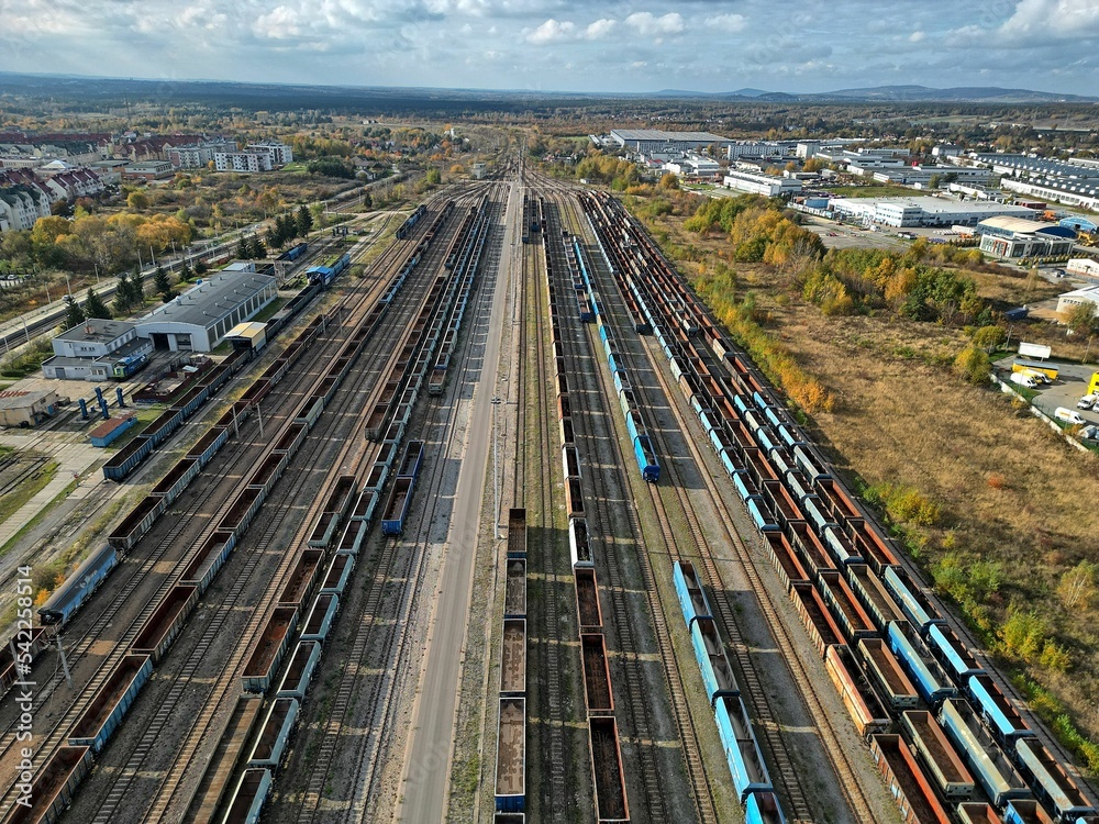 empty wagons are waiting at the train station for coal to be taken to the power plant