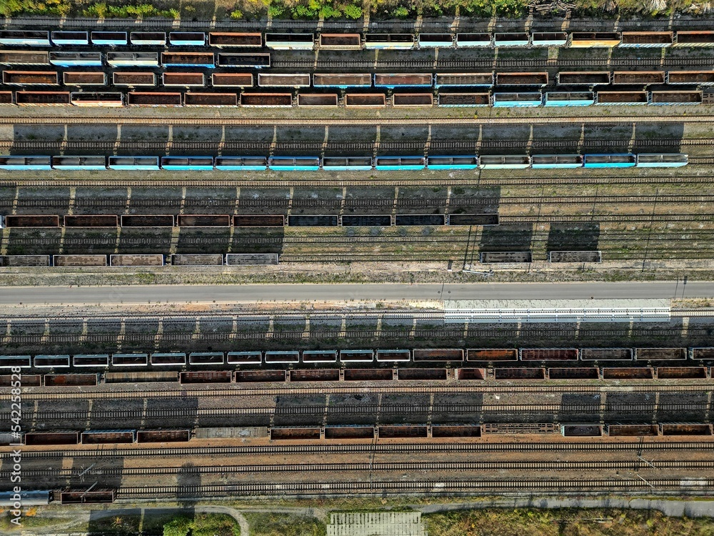 empty wagons are waiting at the train station for coal to be taken to the power plant