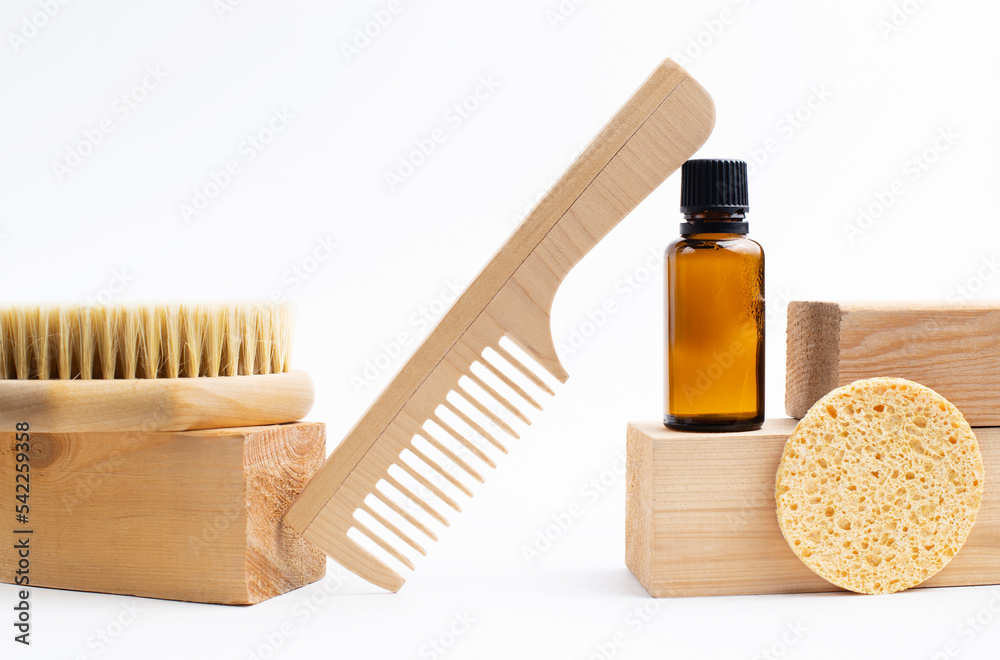 wooden comb, glass bottle,natural bristle brush,sponge on a white background - obrazy, fototapety, plakaty 