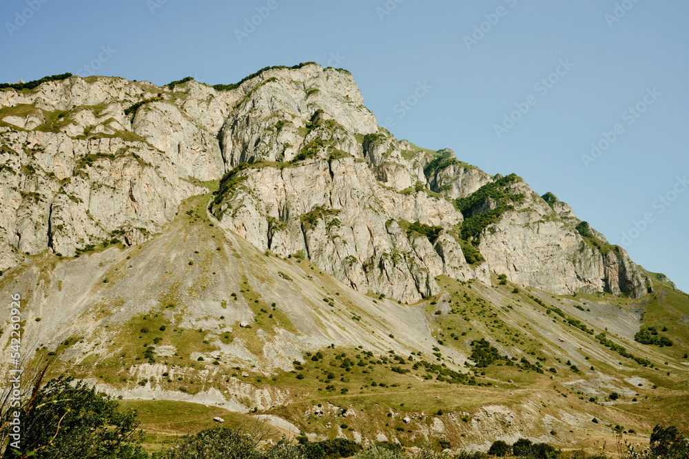 Rocky mountain peak against blue sky. North Ossetia-Alania, Russia.