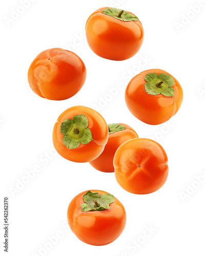 Falling persimmon isolated on white background, clipping path, full depth of field photo