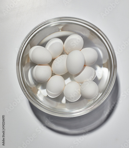 Eggs in water in glass bowl