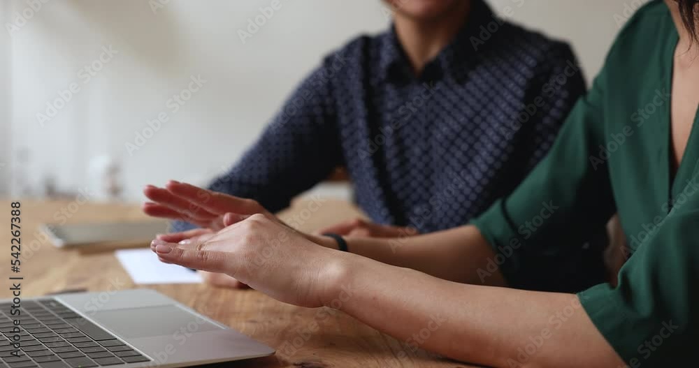 Cropped view two businesswomen talk sit at desk with laptop, gesticulating while express opinion, make speech at formal meeting in office with client, offers company services, colleagues discuss task Cropped view two businesswomen talk sit at desk with laptop, gesticulating while express opinion, make speech at formal meeting in office with client, offers company services, colleagues discuss task