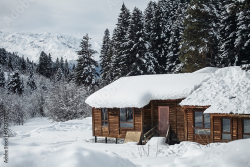wooden hut in the mountains in winter