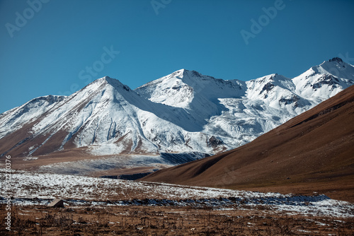 Caucasian mountains covered with snow on a sunny day © Елена Вырыпаева