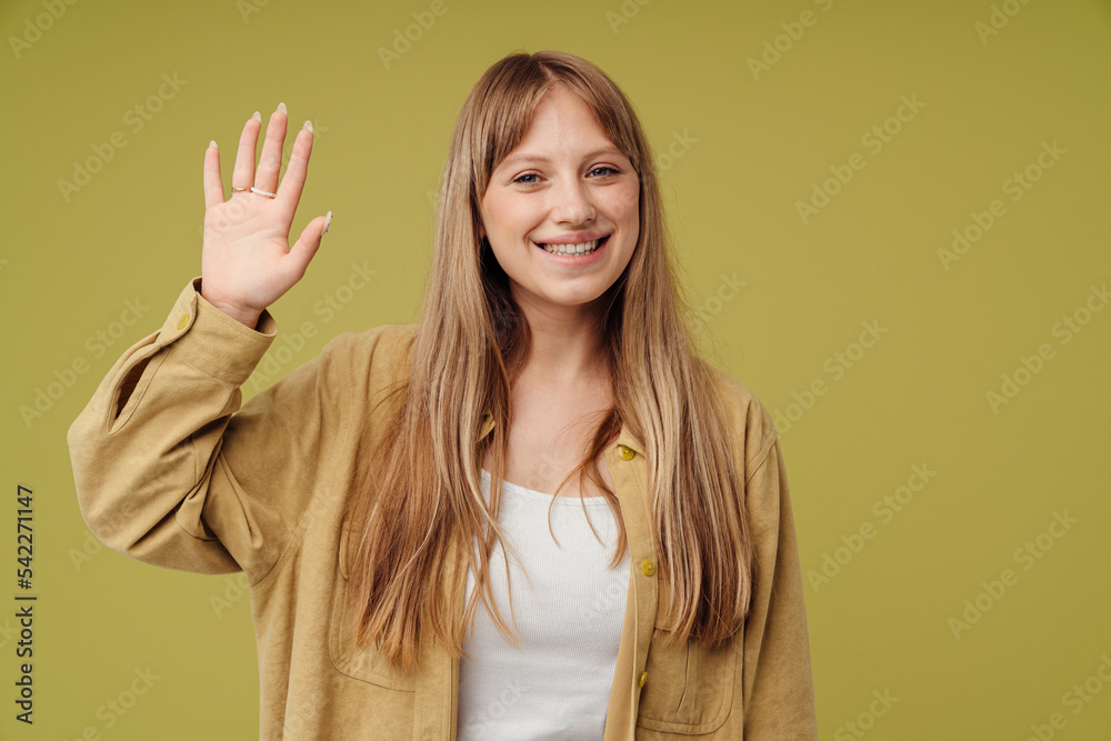 White blonde woman wearing shirt waving hand and smiling White blonde woman wearing shirt waving hand and smiling