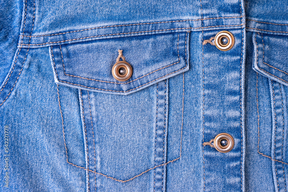 Denim jeans texture background with pocket. Texture of blue colored cotton fabric with decorative seam and buttons. Stitched texture jeans background. Fiber and fabric structure. Fashion, shopping Denim jeans texture background with pocket. Texture of blue colored cotton fabric with decorative seam and buttons. Stitched texture jeans background. Fiber and fabric structure. Fashion, shopping