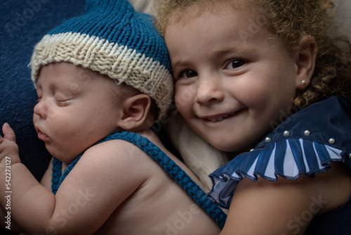 Fototapeta Little girl hugging her newborn brother